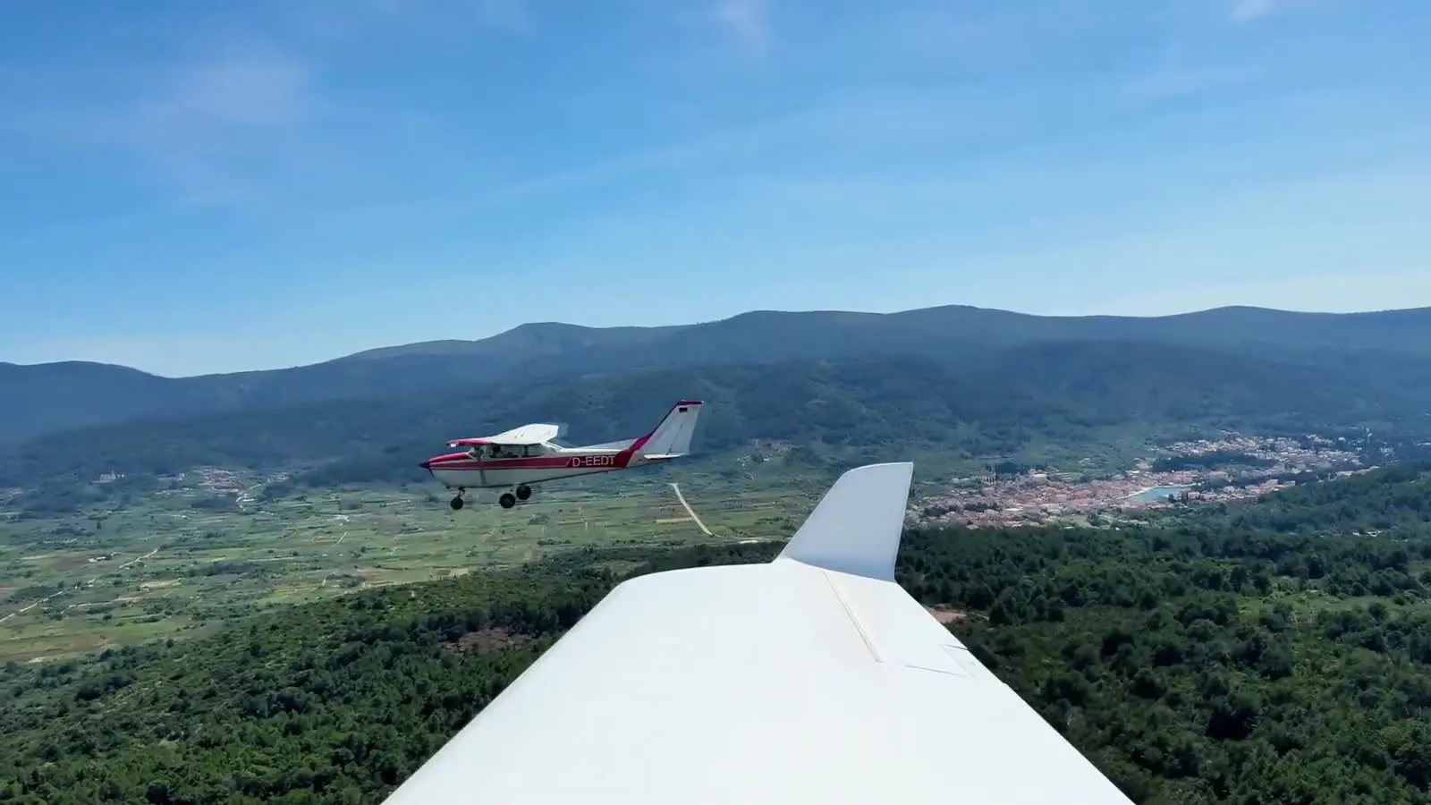 A Cessna in flight above the fields and towns of Hvar island